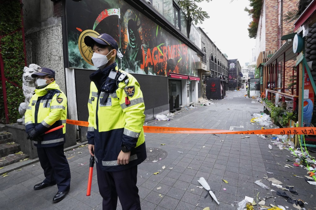Police officials stand guard in front of empty scene of a deadly accident that happened during Halloween festivities in Seoul, South Korea in October 2022. Photo: AP
