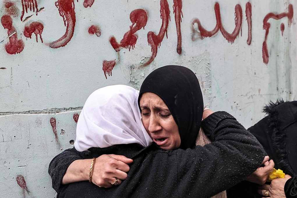 A woman consoles another woman after three Palestinian men were killed when undercover Israeli agents raided the Ibn Sina hospital in the city of Jenin. Photo: AFP