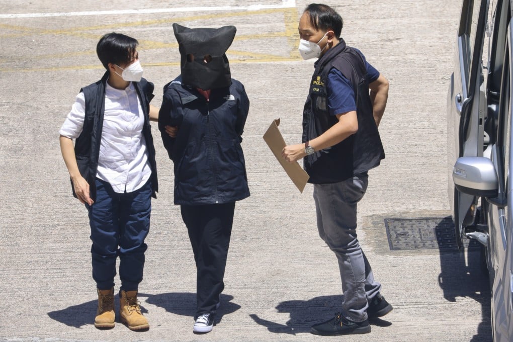 Quinn Moon (centre) is escorted by Hong Kong police officers to Tin Shui Wai Police Station. She has been sentenced to five years and a month in jail. Photo: Dickson Lee