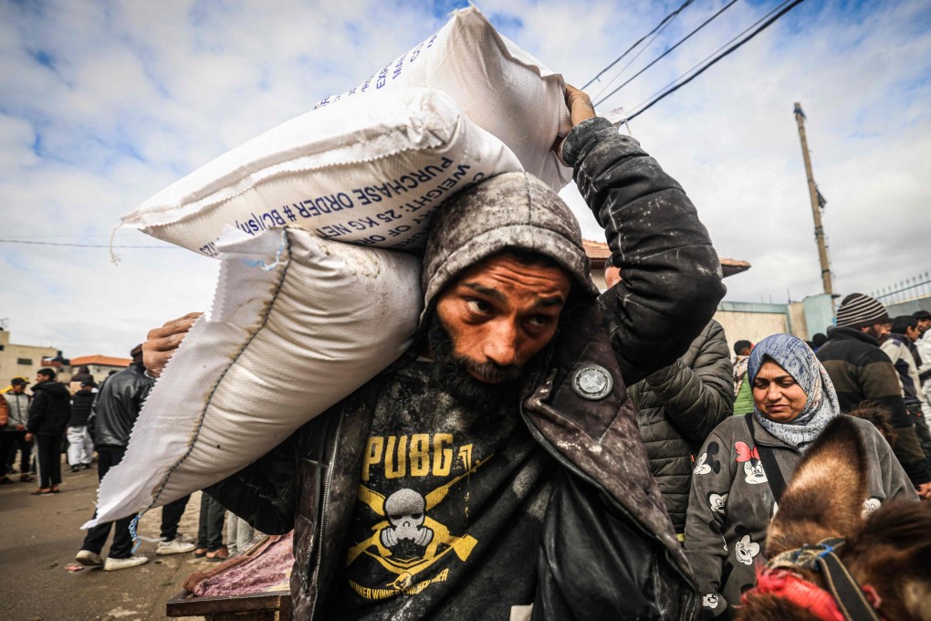 Displaced Palestinians receive food aid at the United Nations Relief and Works Agency for Palestine Refugees (UNRWA) center in Rafah. Photo: AFP