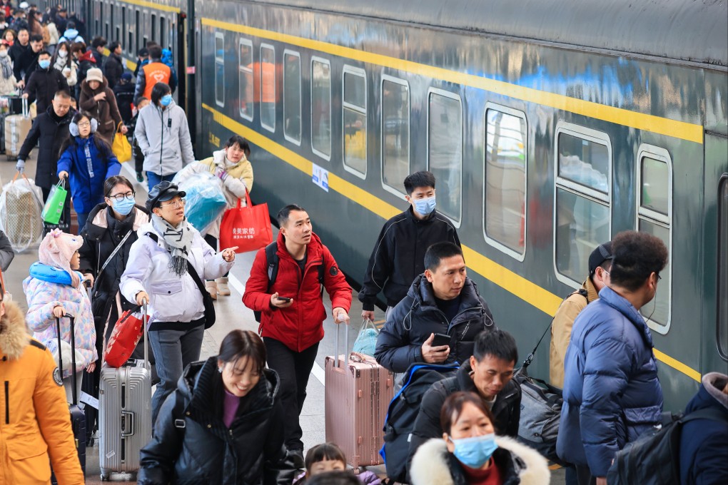 Passengers queue to board a train in Nanjing, in Jiangsu province, China, on January 25. Lunar New Year in China means getting together with family, and with 9 billion domestic trips expected, it seems everyone in the nation will be on the go during the holiday. Photo: Getty Images