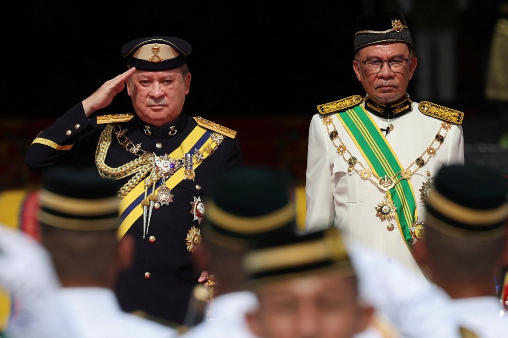 Sultan Ibrahim Iskandar of Johor (left), beside Prime Minister Anwar Ibrahim, salutes a guard of honour at the National Palace in Kuala Lumpur on Wednesday during his coronation as Malaysia’s 17th king. Photo: Reuters
