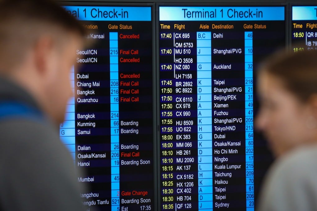 Passengers check flight information at Hong Kong International Airport, Chek Lap Kok. Cathay Pacific has promised better performance in the wake of a spate of flight cancellations. Photo: Xiaomei Chen