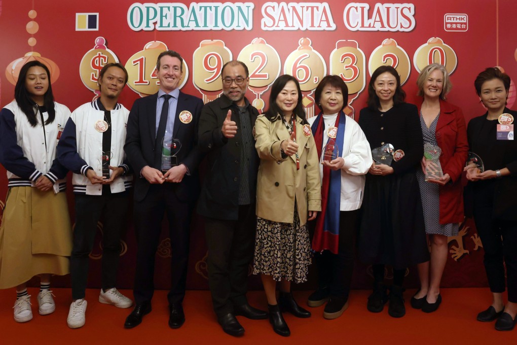 The Operation Santa Claus closing ceremony, with (from left) Peony Ho, Evan Li, David Wallis, Vincent Lee, Post editor-in-chief Tammy Tam, Mary Lam, Yen Lee, Rebecca Marans and Grace Yen. Photo: Jonathan Wong