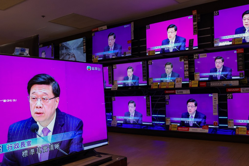 Televisions broadcast city leader John Lee’s press conference kicking off consultation on the new domestic security law. Photo: Jelly Tse