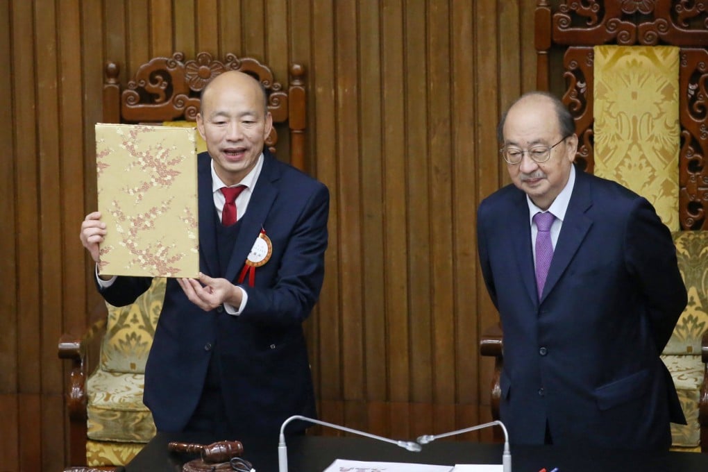 Han Kuo-yu (left) holds a certification document beside DPP legislative caucus leader Ker Chien-ming after being elected Speaker of the Legislative Yuan. Photo: AFP