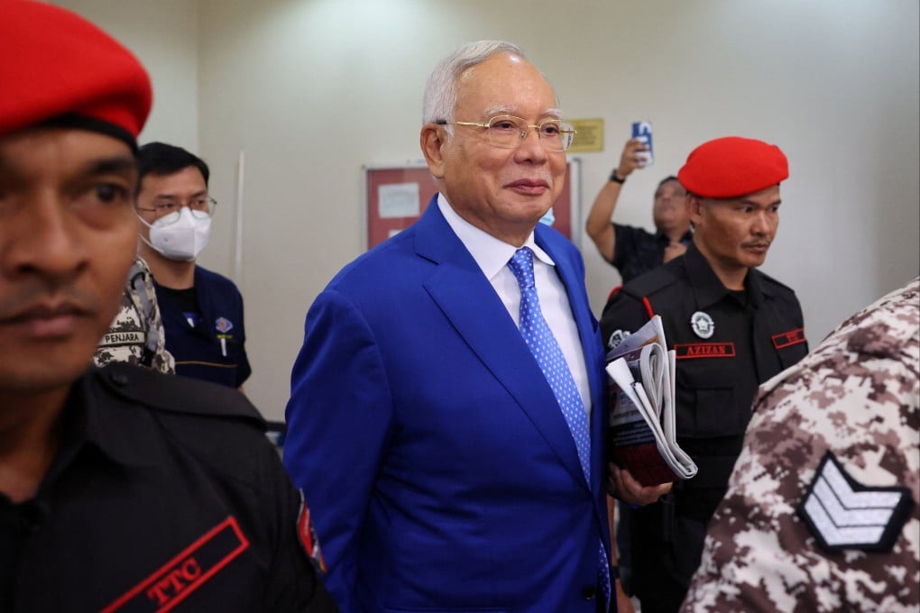 Former Malaysian prime minister Najib Razak leaves a court in Kuala Lumpur last month escorted by prison officials. Photo: Reuters