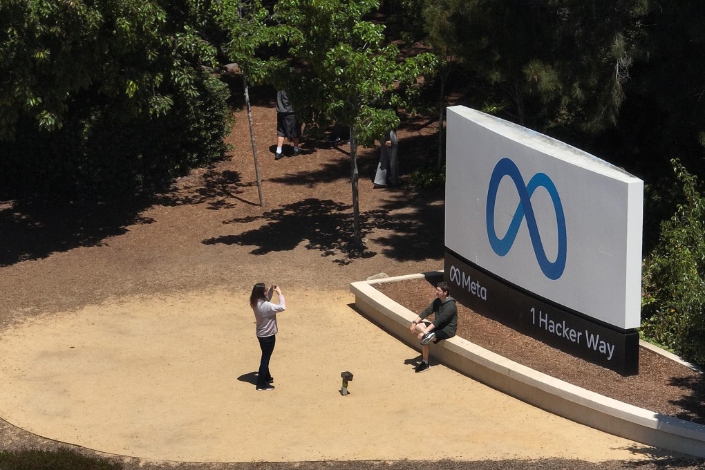In an aerial view, people take pictures in front of a sign at Meta Platforms' headquarters in Menlo Park, California, on July 7, 2023. Photo: Getty Images/TNS