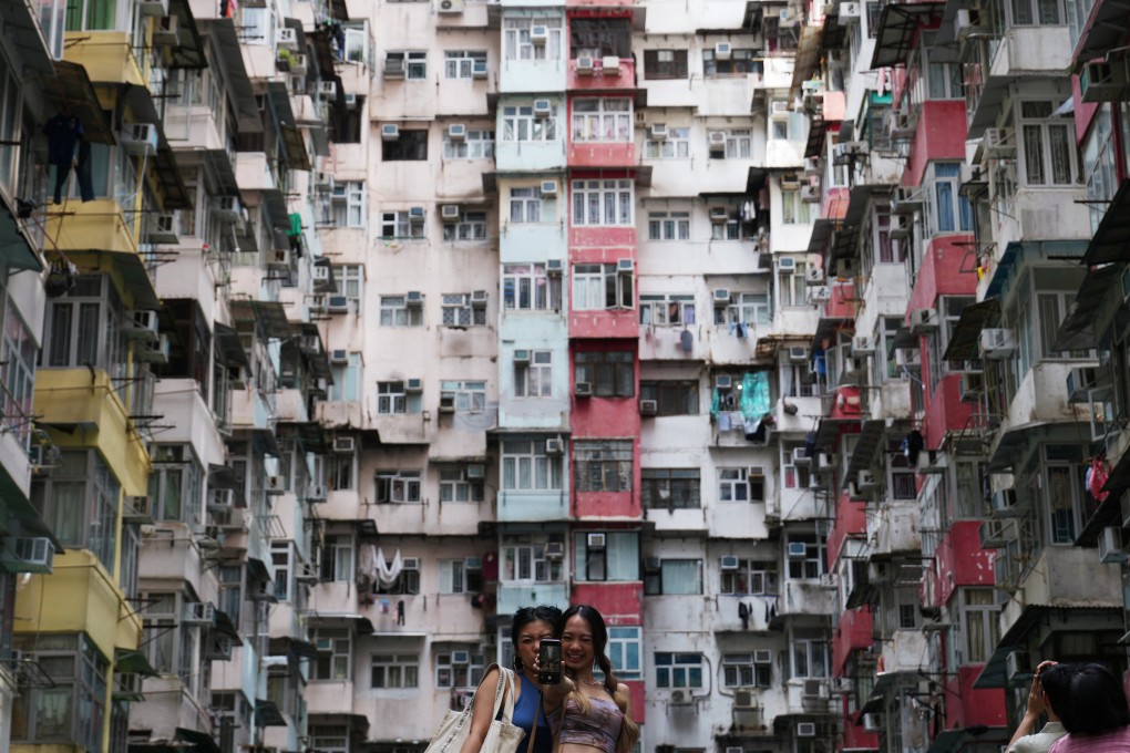 Tourists take photos at Montane Mansion, also known as the “Monster Building”, in Quarry Bay in 2023. The popularity of the building, which  was featured in a Transformers movie, is just one example of changing tourist tastes. Photo: Sam Tsang
