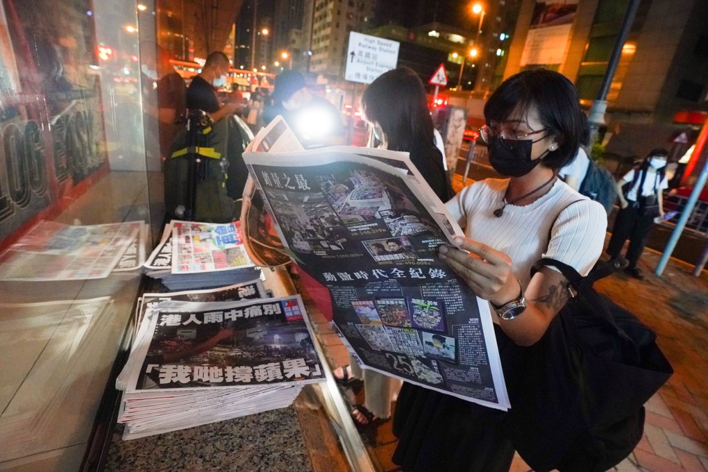 People flip through the last edition of Apple Daily in Mong Kok in 2021. The tabloid ran a series of articles about the national security law’s impact on Hong Kong. Photo: Felix Wong