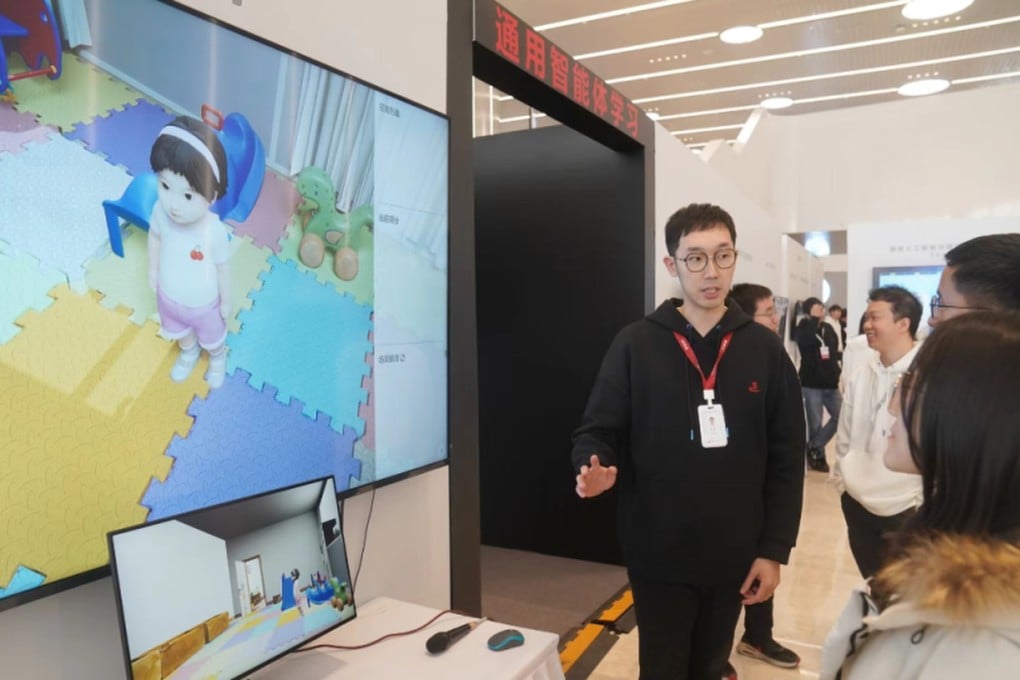A researcher from the Beijing Institute for General Artificial Intelligence explains how to interact with Tong Tong at the Frontiers of General Artificial Intelligence Technology Exhibition in Beijing in late January. Photo: bjd.com
