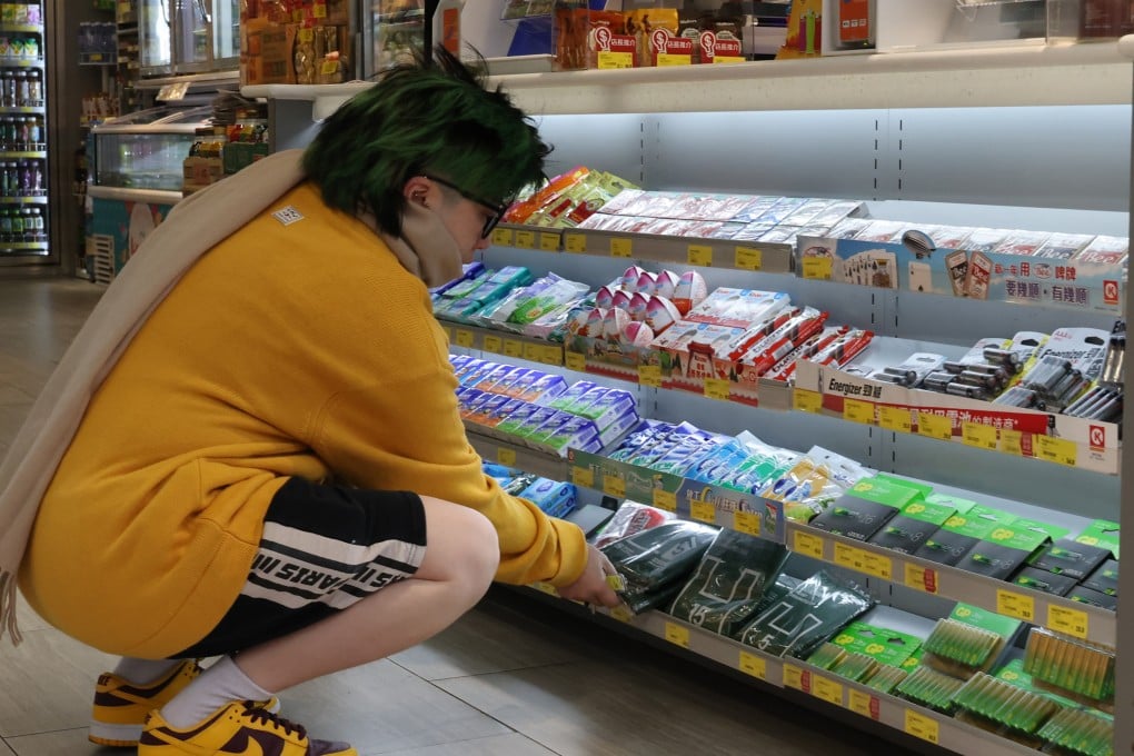 A shopper looks at designated rubbish bags for the waste-charging scheme in a convenience store in Mong Kok on January 26. Photo: Jelly Tse