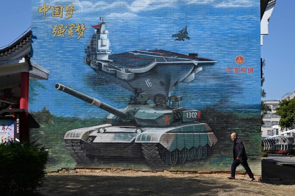 A man walks past a military-themed mural on Pingtan Island in Fujian province, the closest point in mainland China to Taiwan, on January 14. Photo: AFP