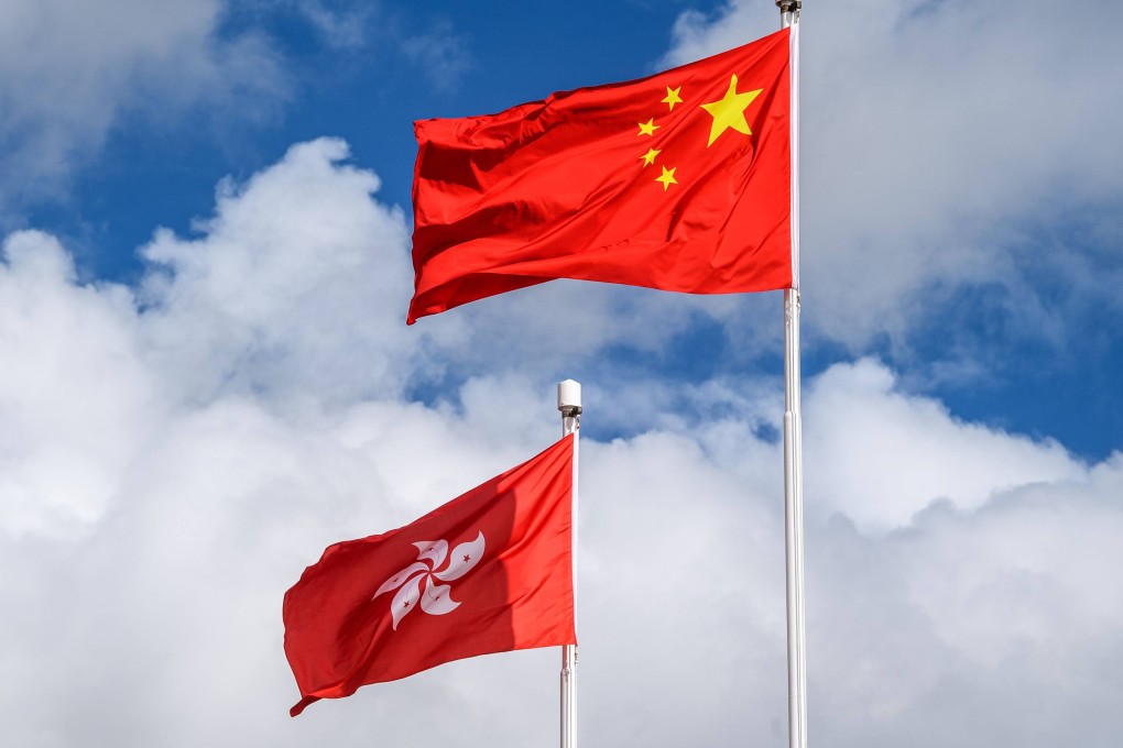 The Chinese (R) and Hong Kong (L) flags are seen hoisted at the end of a flag-raising ceremony to mark the 23rd anniversary of Hong Kong’s handover from Britain in Hong Kong on July 1, 2020. Photo: AFP