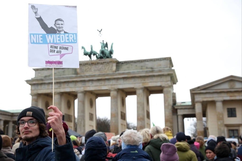 A demonstrator in Berlin, Germany, holds up a placard showing a far-right leader giving the Nazi salute and reading ‘Never Again’, as people demonstrate against extremism and the policy of the anti-immigration Alternative for Germany (AfD) party. File photo: AFP