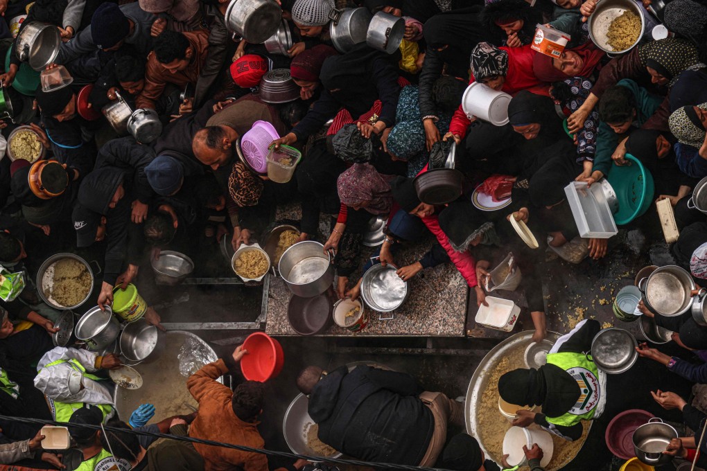 Palestinians receive food rations at a camp in Rafah in the southern Gaza Strip on February 2. Photo: AFP