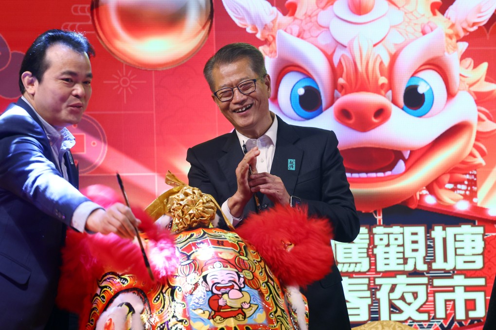 Finance chief Paul Chan (right) attends an opening ceremony for a Lunar New Year night market. Photo: Dickson Lee
