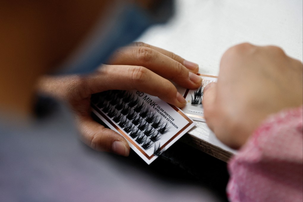 An employee works on a production line manufacturing false eyelashes in China’s Shandong province. File photo: Reuters