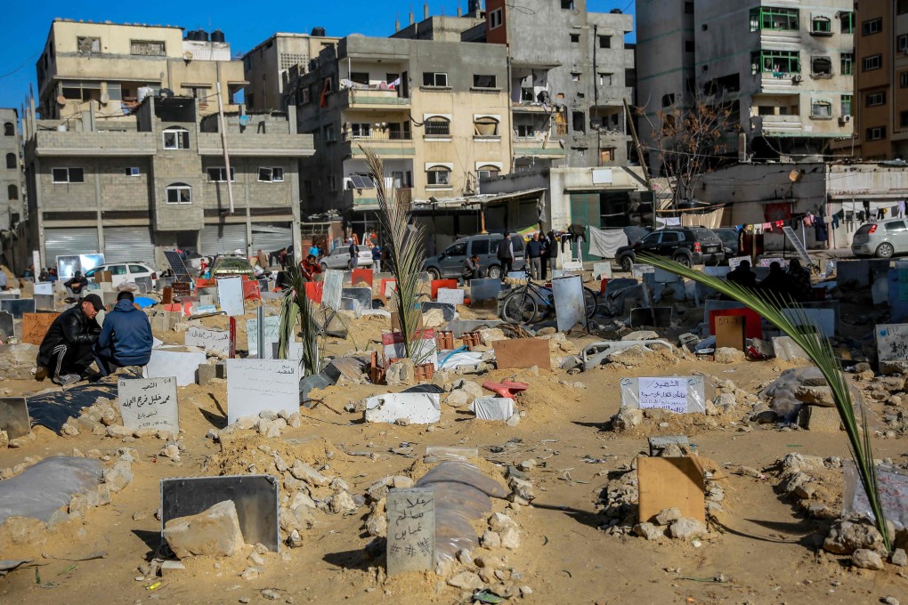 Placards indicating the names of people killed in Israeli bombardments are placed on shallow tombs at a makeshift cemetary in Gaza City in January. Photo: AFP