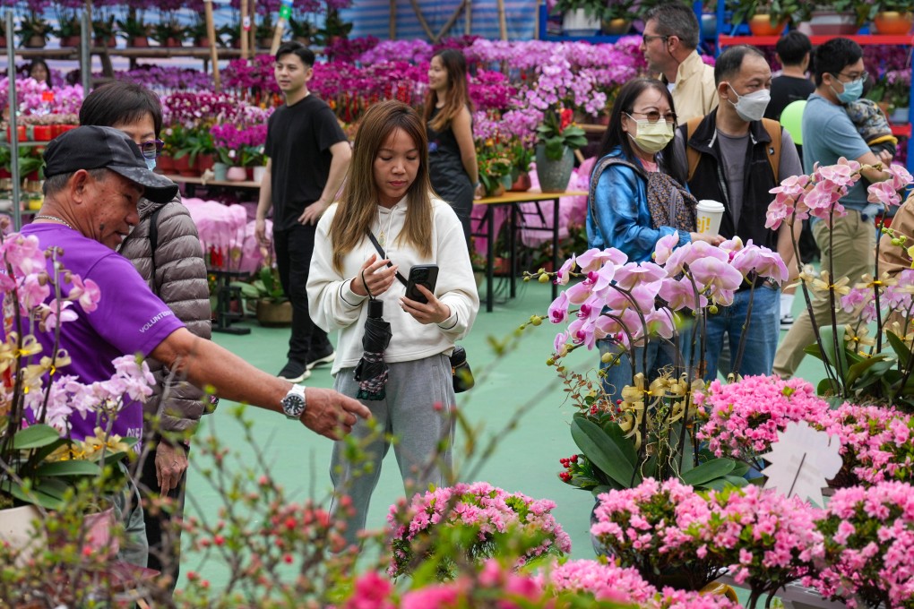 Shoppers at the Lunar New Year fair in Victoria Park browse the flowers on sale. Photo: Eugene Lee