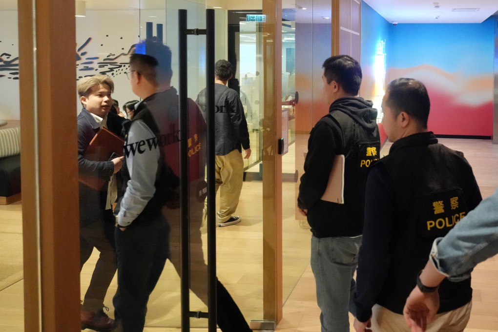 Police officers enter KeeTa’s offices at Lee Garden One. Photo: Sam Tsang