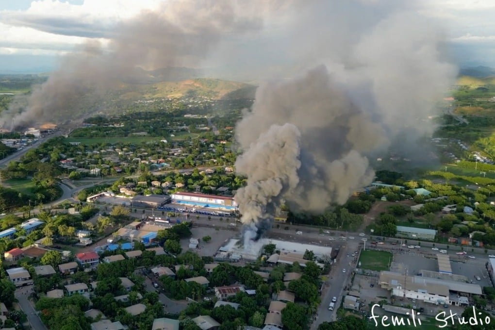 An aerial view of smoke billowing from burning buildings in Port Moresby, Papua New Guinea, last month amid looting and arson during widespread protests and riots. Photo: Femli Studio via Reuters