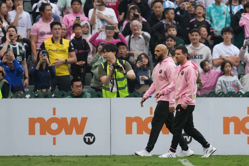 The non-involvement of Lionel Messi (right, with his bodyguard) disappointed most of those present. Photo: Sam Tsang