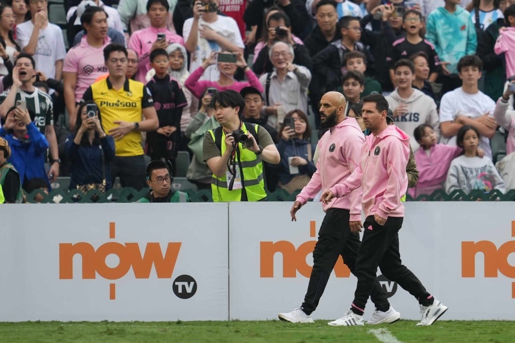 The non-involvement of Lionel Messi (right, with his bodyguard) disappointed most of those present. Photo: Sam Tsang