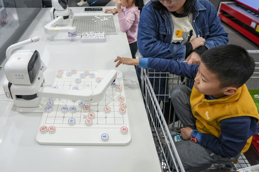 A boy plays chess with a robotic arm powered by artificial intelligence at a Sam’s Club in Qianhai, Shenzhen, on January 7. While Hongkongers are showing great interest in heading north to shop in megastores, Shenzhen also offers some lessons in urban planning. Photo: Eugene Lee