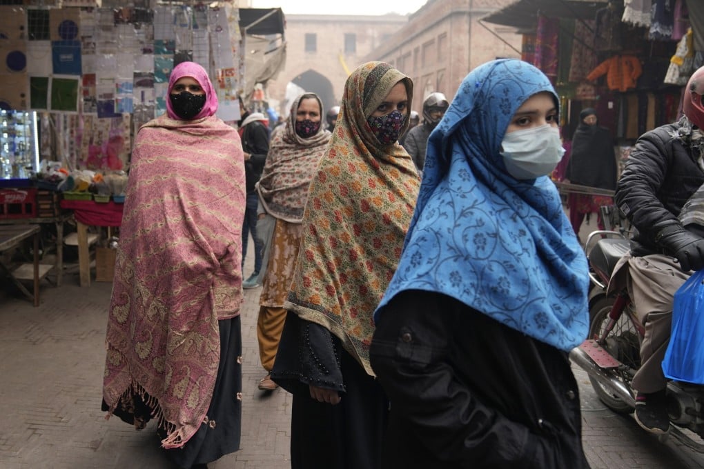 Women visit a market in Lahore. In some rural Pakistan villages, women are forbidden from voting by their male elders. Photo: AP