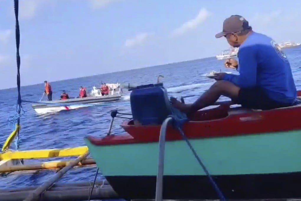 Chinese coastguard on rubber boats pass a Philippine fishing boat at the disputed Scarborough Shoal off the northwestern Philippines. The Philippines has in the past accused the Chinese coastguard of confronting its ships, including firing water cannons at them. Photo: AP