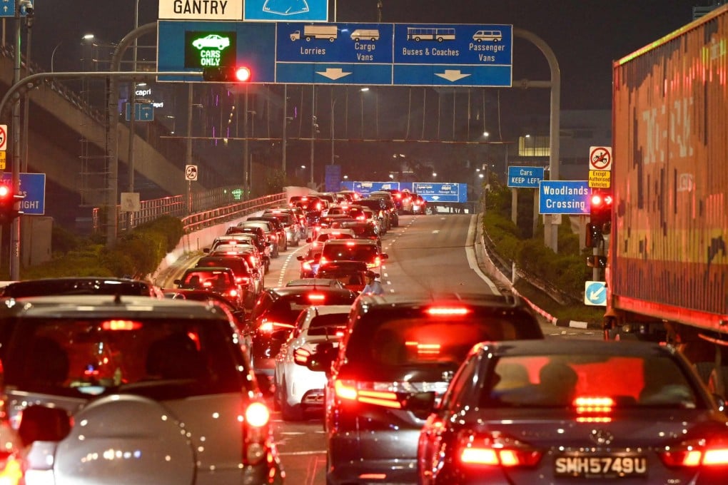 Vehicles queue to enter the Woodlands Checkpoint in Singapore before crossing the causeway to Malaysia’s southern Johor state. Photo: AFP