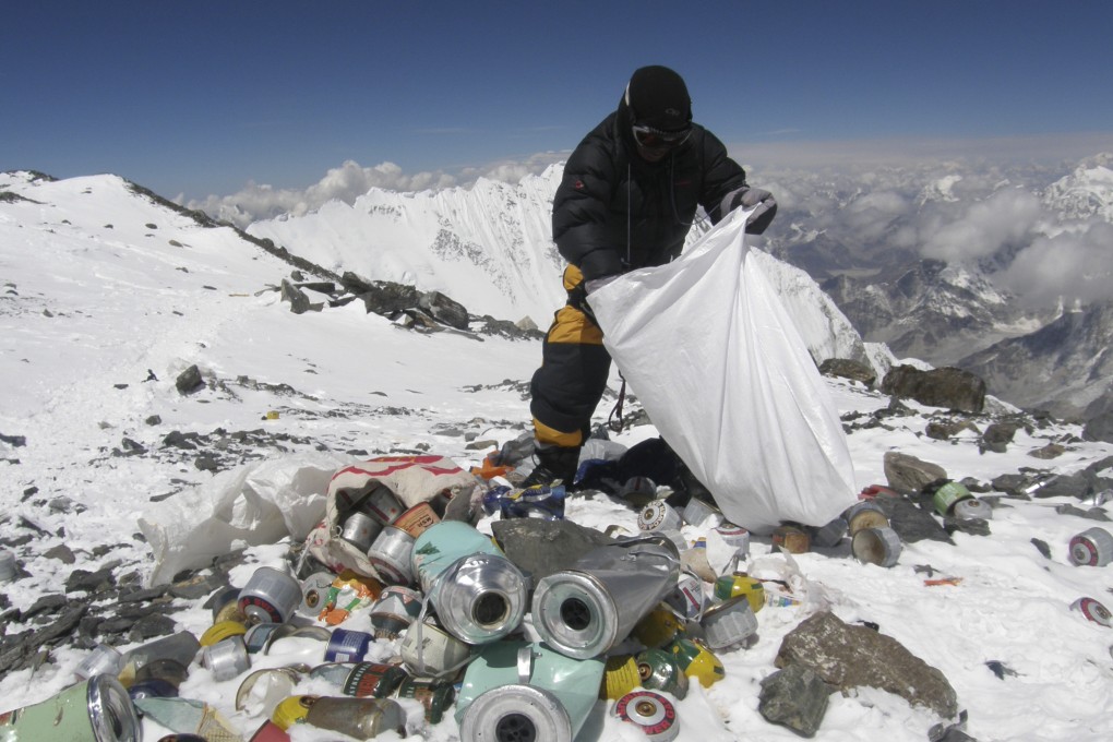 A Nepalese sherpa collecting garbage, left by climbers, at an altitude of 8,000 metres during the Everest clean-up expedition at Mount Everest. Photo: AFP