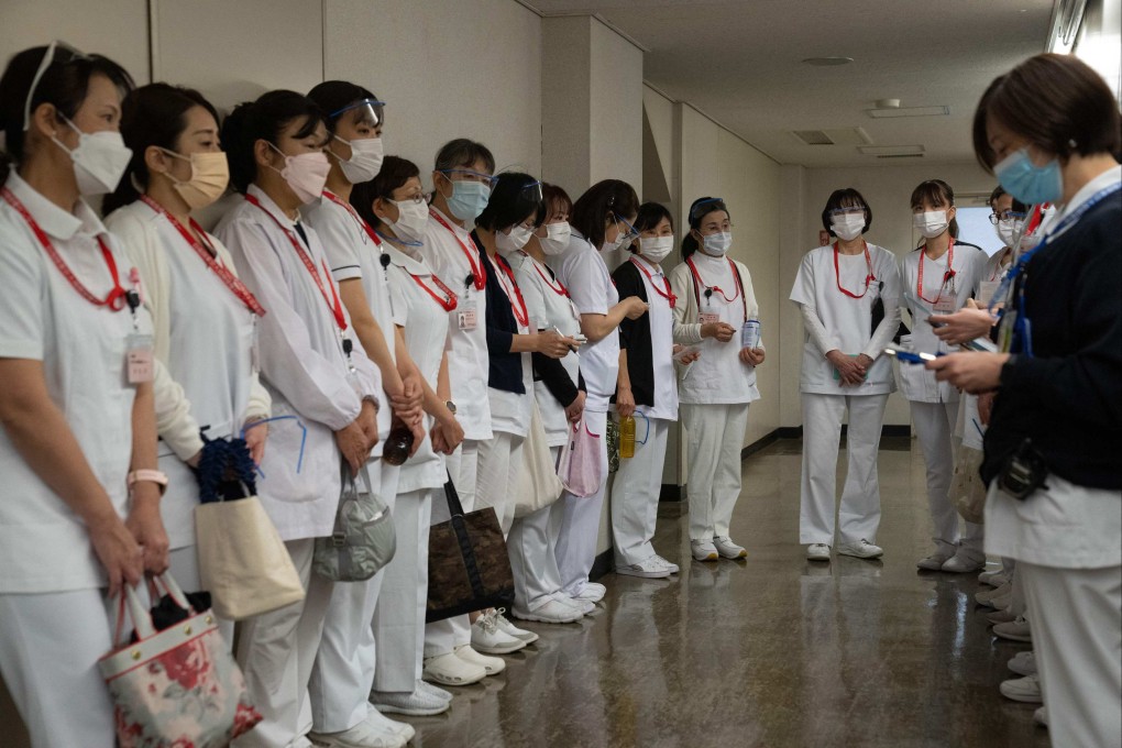 Nurses at a Covid-19 mass vaccination centre in Tokyo on November 17, 2021. Photo: AFP