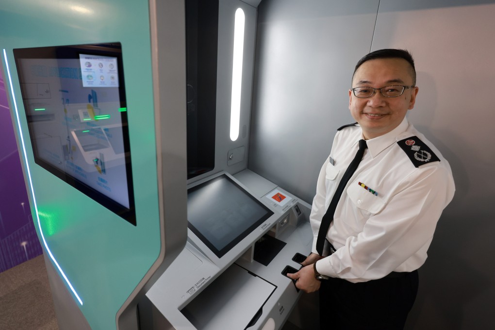 Director of Immigration Benson Kwok    shows off his department’s new self-service document submission kiosk. Photo: May Tse