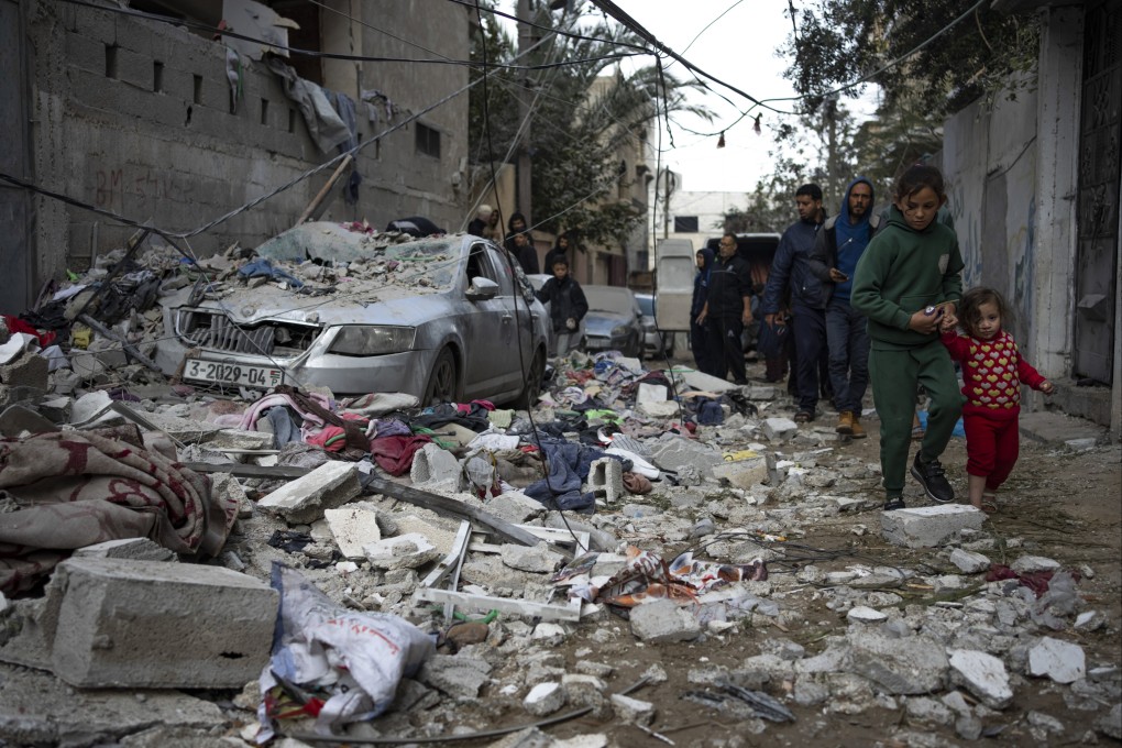 Palestinians look at the destruction after an Israeli airstrike in Rafah, Gaza, on Friday. Photo: AP