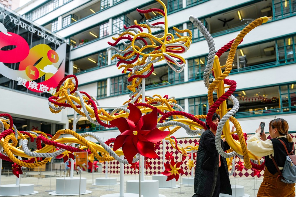 People take pictures in front of a Year of the Dragon display at PMQ in Sheung Wan, Hong Kong on February 3, 2024. Photo: Eugene Lee
