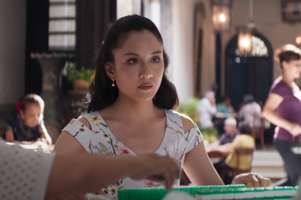 Constance Wu as Rachel in a scene from Crazy Rich Asians in which, playing opposite Eleanor (Michelle Yeoh), mother of the man she loves, she picks up a tile that would win her the game but discards it, knowing it will allow Eleanor to win. How you play mahjong shows the kind of person you are. Photo: Warner Bros.