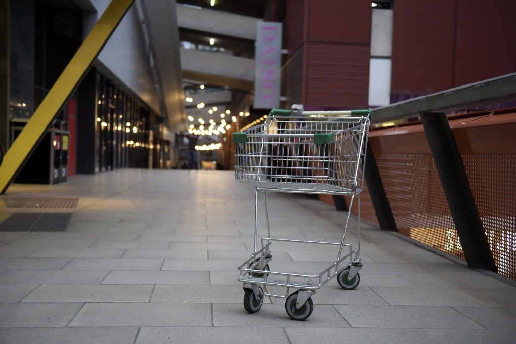 A shopping cart stands on a deserted walkway at the Queen Victoria Village precinct in Melbourne. Many countries face similar supply chain and inflation woes, but the sting was greater for Australians after Coles and Woolworths each made a profit of over A$1 billion (US$650.6 million) last year. Photo: Bloomberg