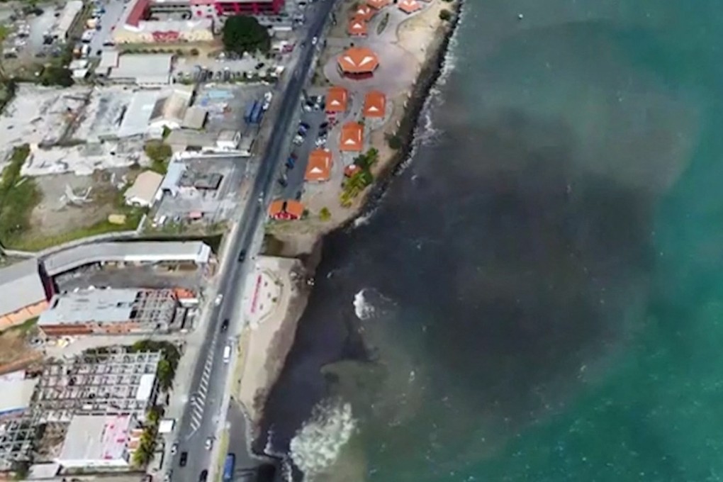 Emergency workers are trying to clean up a huge oil spill after a vessel ran aground in the Caribbean, just when thousands of tourists are expected to arrive for carnival season. Photo: Handout via AFP