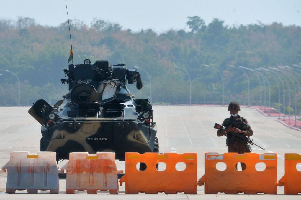 A soldier stands guard on a blockaded road to Myanmar’s parliament in Naypyidaw in February 2021. Photo: AFP