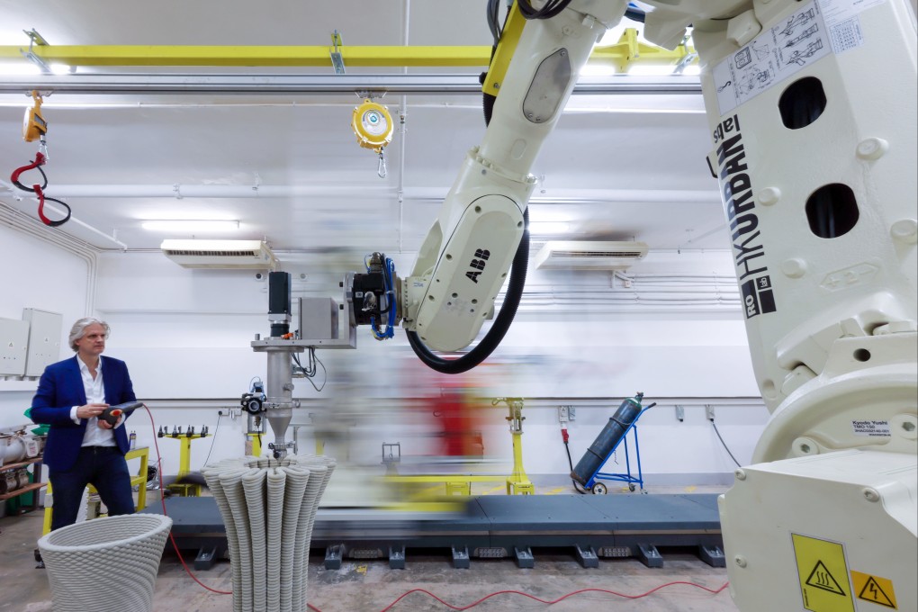 Architect Christian Lange operates a 3D printer at his team’s lab. The University of Hong Kong site features two large robots on tracks which swiftly alternate between concrete printing, picking and placing, and welding. Photo: Dickson Lee