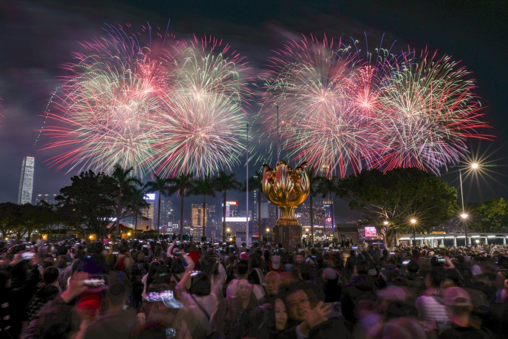 Spectacular red, green and gold pyrotechnics sparkle in the night sky above Victoria Harbour. Photo: Eugene Lee