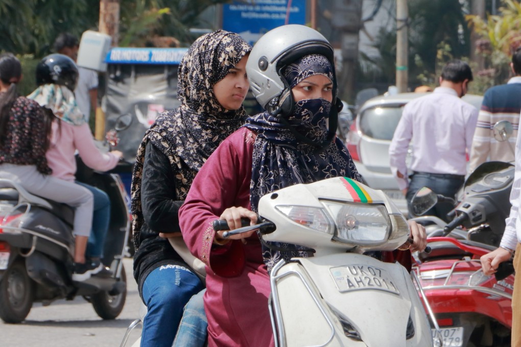Women ride a scooter in Uttarakhand, India. Photo: Shutterstock