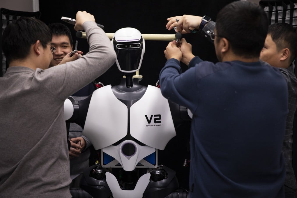 Researchers adjust a humanoid robot at an AI laboratory in Beijing on January 31. Photo: Xinhua