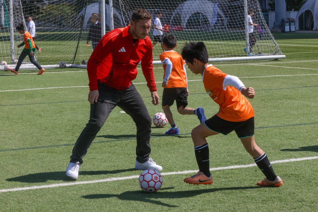 World Cup winner and Roma legend Francesco Totti helps put some local youngsters through their paces at the HKFA Training Centre in Tseung Kwan O. Photo: Jonathan Wong