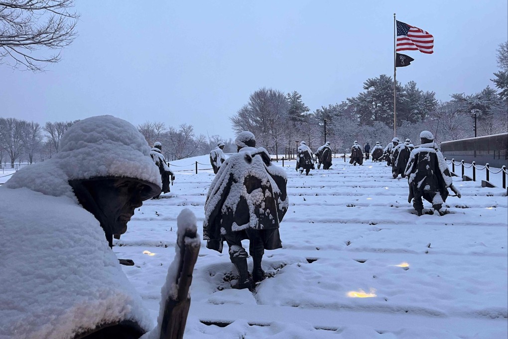 Statues at the Korean War Veterans Memorial on the National Mall are covered in snow during a storm in Washington on January 19. Photo: AFP
