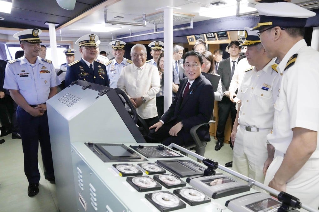 Japanese Prime Minister Fumio Kishida (seated) visits a Philippine Coast Guard vessel in Manila on November 4, 2023, during a three-day official visit to Southeast Asia. Photo: Kyodo