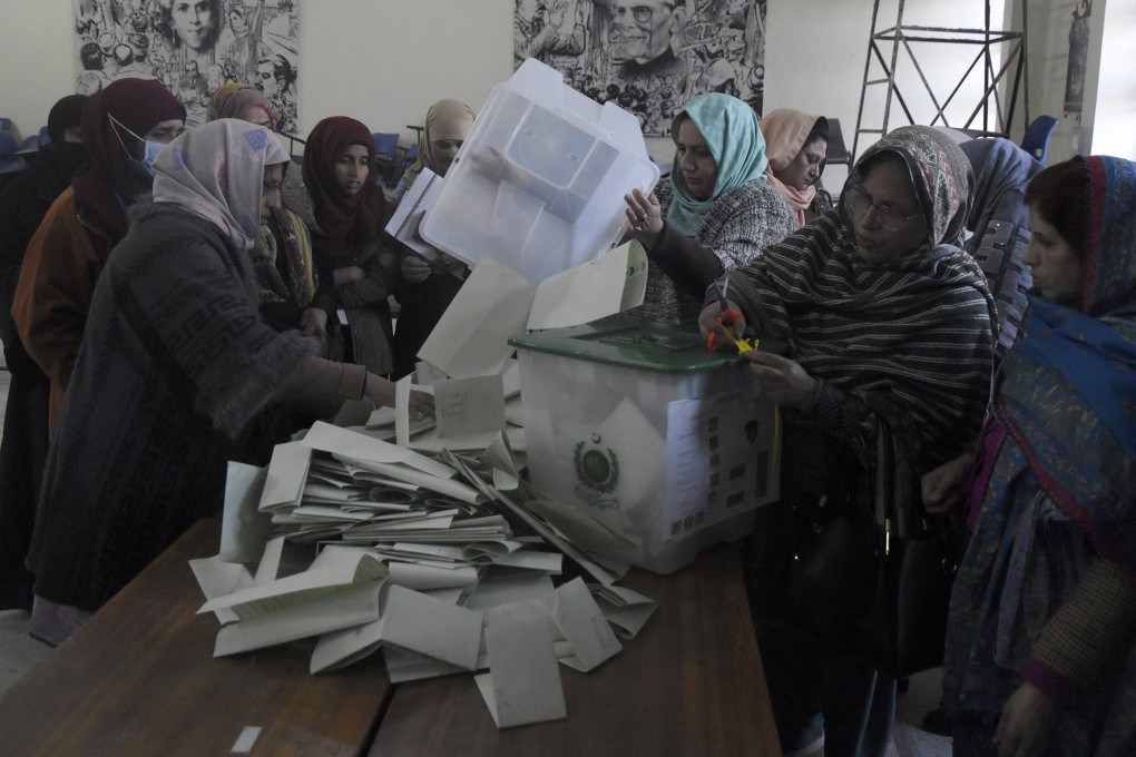 Members of polling staff empty ballot boxes to start counting the votes after the polls closed for parliamentary elections, in Rawalpindi, Pakistan. Photo: AP