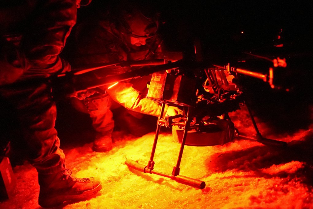 Ukrainian servicemen attach an anti-tank mine to a vampire combat drone. Photo: Reuters